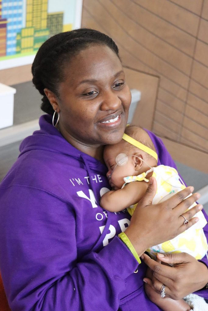 A mother holding her baby