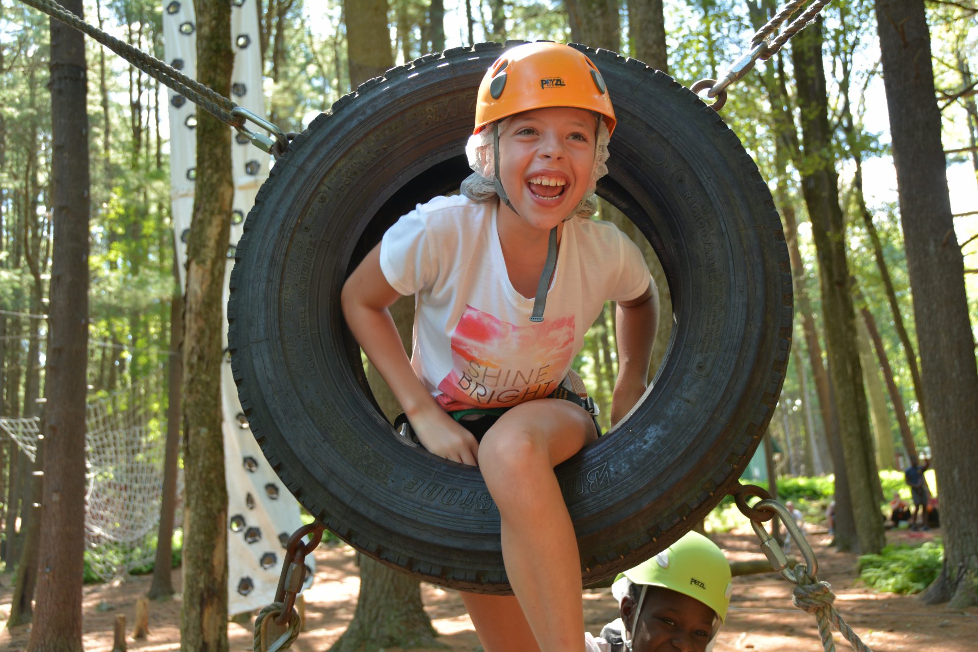 Camper climbing through a tire