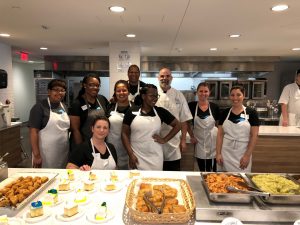 Volunteers from Amerihealth Caritas with food they cooked