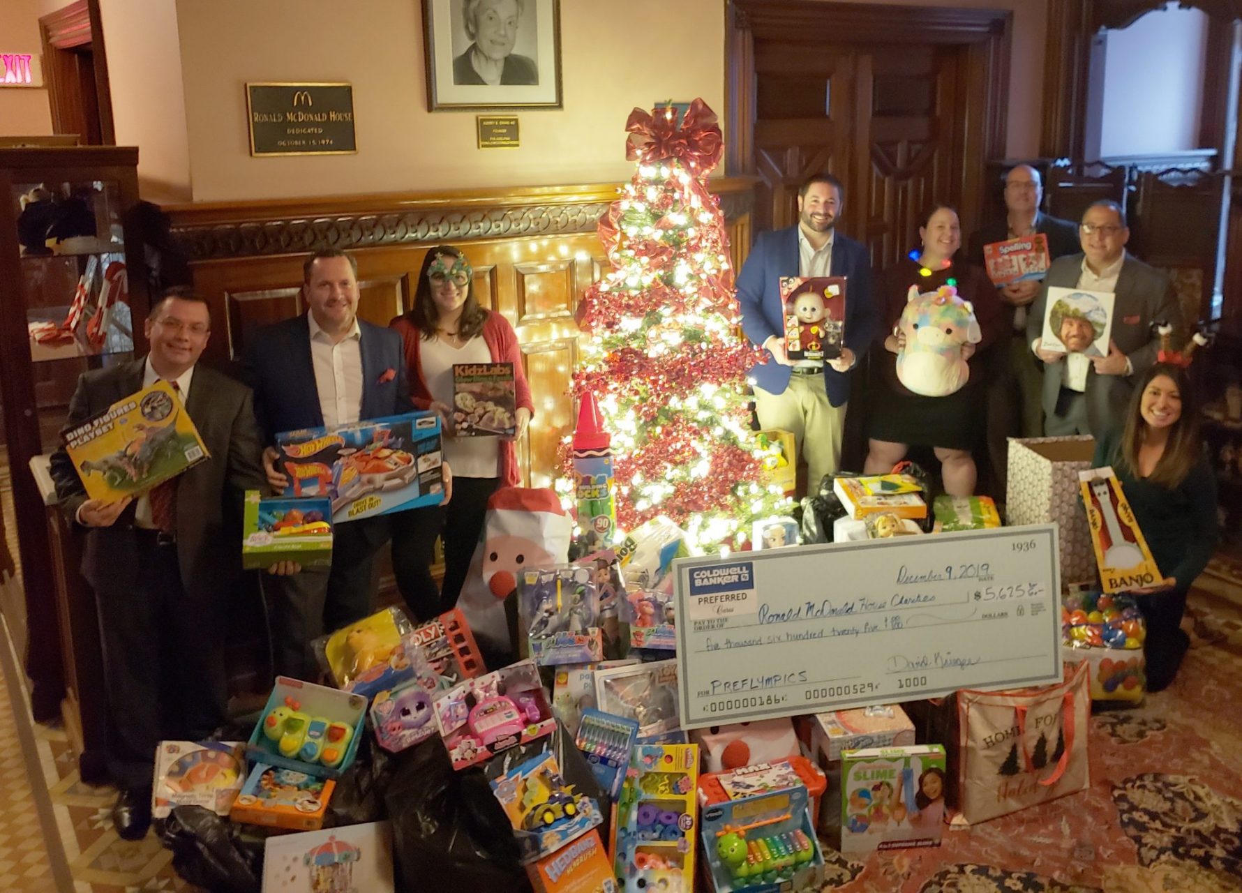Coldwell Banker Preferred employees with items collected in fundraiser
