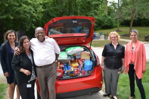 Employees from CSL Behring presenting RMHC Philly staff member with