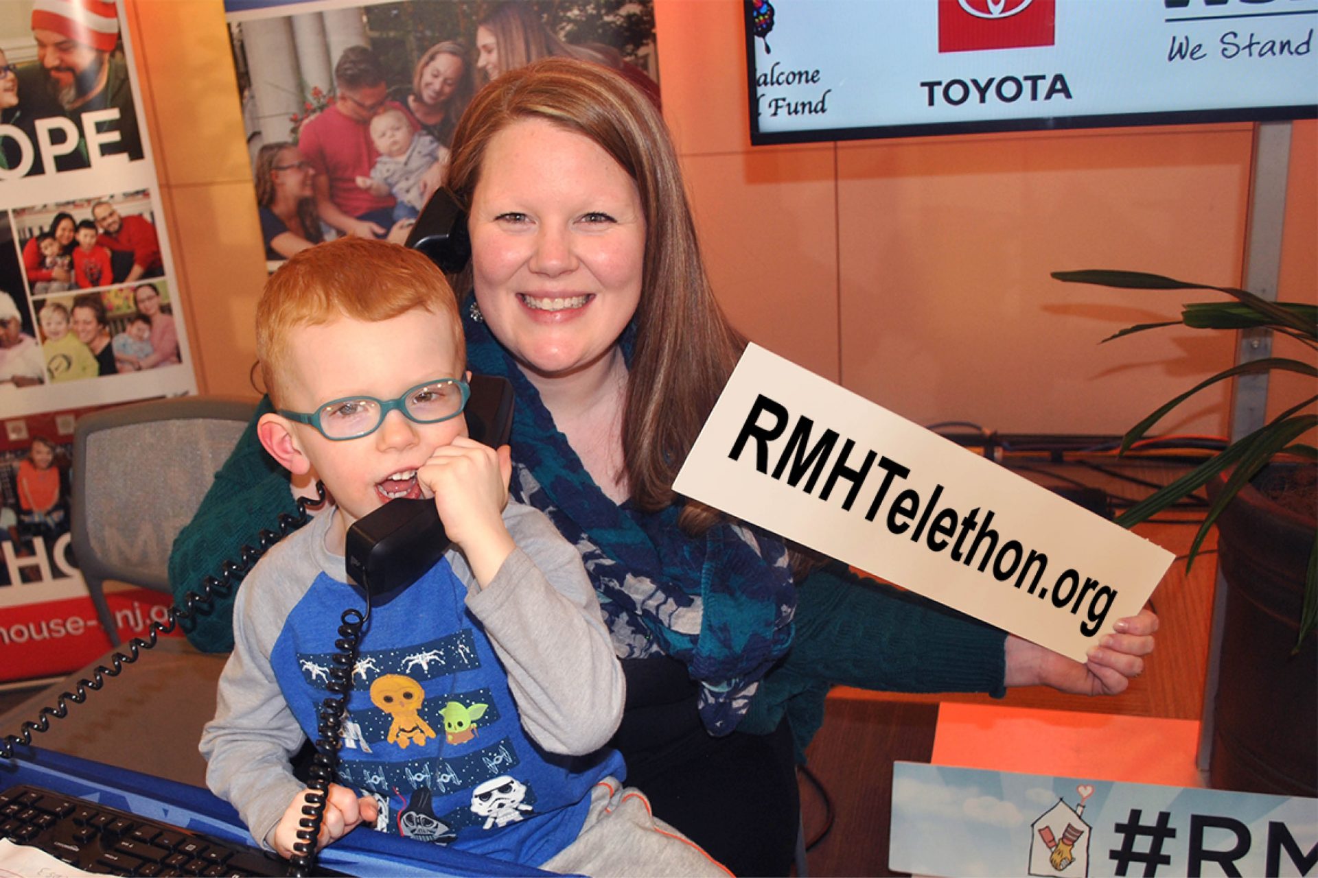 Mom and son answering phones at the Telethon
