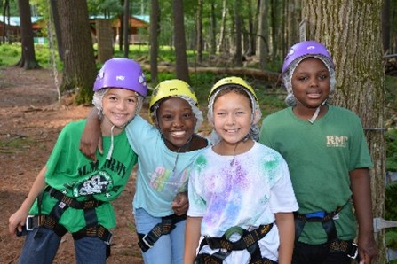 Campers smiling after zip-lining