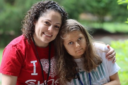 Counselor posing with camper