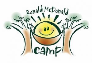 A sun resting on a hammock hung between two trees. reads "Ronald McDonald Camp"