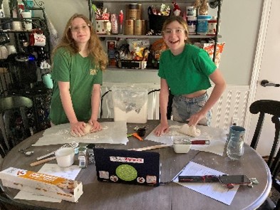 Virtual camper siblings working on a fun project
