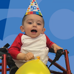 little boy with a party hat on