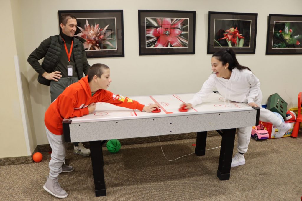 Pavon family playing air hockey