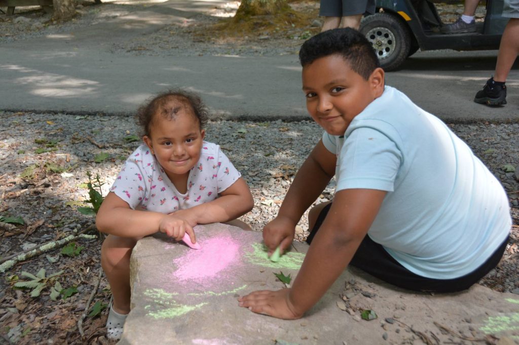 Campers drawing with chalk