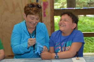 A counselor working with a camper