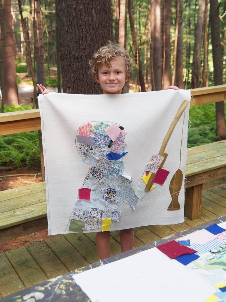Camper holding an art piece