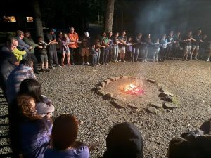 Families around a camp fire.
