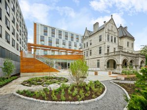 Ronald McDonald House mansion and tower with growing trees in the front